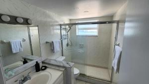 a bathroom with a shower and a toilet and a sink at Bayfront Apartment Breathtaking Views- one bedroom w balcony- living room -Free Parking in Miami Beach