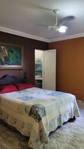 um quarto com uma cama e um quadro na parede em Villa Blue Point - Chácara com piscina e 4 quartos em Vila Velha