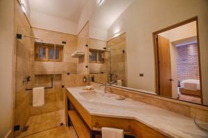 a bathroom with a sink and a large mirror at HOTEL CASA ARANZAZU SAN LUIS POTOSI in San Luis Potosí
