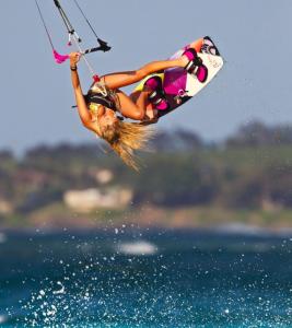 a woman is in the air on a wake board at Nova Aparts in Akyaka
