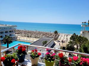 a balcony with a view of a beach and the ocean at Sea View New Apartment in Durrës