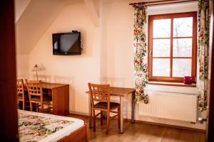 a room with a table and a window and a desk at Mlýn Mitrovice in Příbram