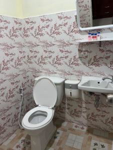 a bathroom with a toilet and a sink at Nopphadon Hotel in Lat Krabang +35 photos