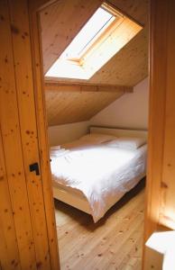 an attic room with a bed and a skylight at Charming Chalet with River View in Michelau
