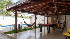 a patio with a hammock and a ping pong table at Casa no Centro de Pirenópolis in Pirenópolis