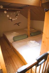 two bunk beds in a room with birds on the wall at Charming Chalet with River View in Michelau