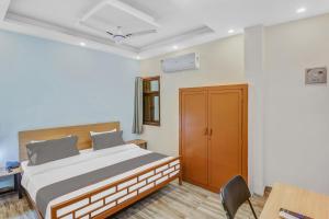 Postel nebo postele na pokoji v ubytování Capital O Moody Inn