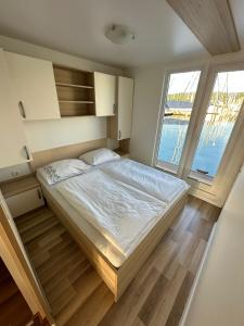 a bedroom with a bed and a large window at Sunset Joy in Portorož
