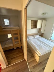a small bedroom with a bed and a desk at Sunset Joy in Portorož