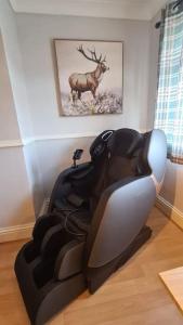 a leather reclining chair in a living room at Cabin of Light - Hot Tub, Sauna, Massage Chair, BBQ, Games, Beach in Monkwearmouth