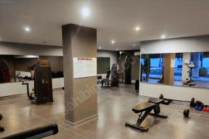 a gym with treadmills and machines in a room at Manavgat - Superb 2 bedroom apartment near beach and Side centre in Side