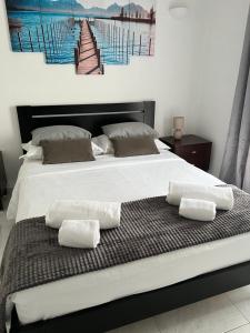 a bed with two white pillows on top of it at Apartamento Sunny in Albufeira