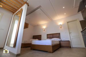 Ένα ή περισσότερα κρεβάτια σε δωμάτιο στο Immeuble Gazbar