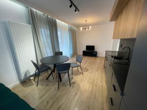 a kitchen and dining room with a table and chairs at Marcelin Business & Family in Poznań