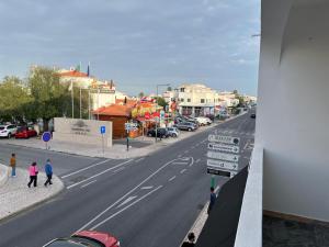 a view of a street with people walking down the street at Apartamento Sunny in Albufeira