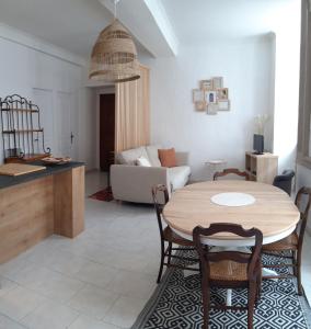 a living room with a table and a couch at Le marronnier in Valleraugue