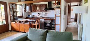 a kitchen with a couch in front of a kitchen at Casa Cicala in Trarego +27 photos