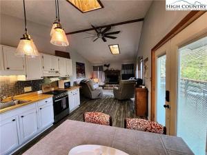 a kitchen with white cabinets and a ceiling fan at Cozy Cabin Walkable to Beech Mt Resort in Beech Mountain