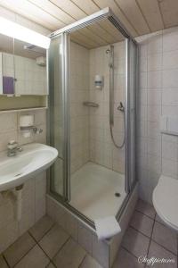 a bathroom with a shower and a sink at Hotel Krone Uetendorf in Uetendorf