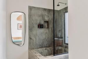 a bathroom with a shower and a mirror at Residencia Tropical Don Bonito in Sayulita