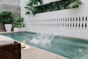 a swimming pool with a fountain in a house at Residencia Tropical Don Bonito in Sayulita