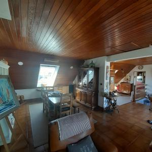 a living room with a wooden ceiling and a table at Gites des menhirs in Camaret-sur-Mer