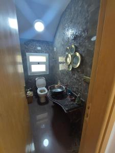 a bathroom with a sink and a toilet and a window at Hacienda bay villa in Sīdī ‘Abd ar Raḩmān
