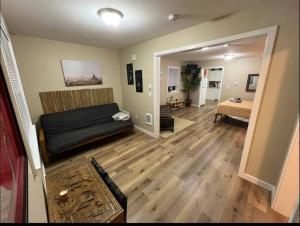 a living room with a couch and a bedroom at Two private apartments in Salem