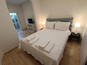 1 dormitorio con 1 cama blanca grande y 2 toallas en Herdade do Montinho en Portalegre