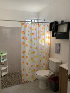 een badkamer met een douchegordijn en een toilet bij Residencia con gran espacio, cómoda y fresca. in Mérida
