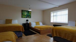 a bedroom with two beds and a window at The Swanky Apartment Manchester in Manchester