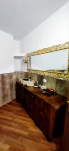 a bathroom with a wooden vanity with a mirror at Villa Mazzini in Molinella