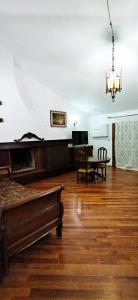 a living room with a bed and a dining room table at Villa Mazzini in Molinella