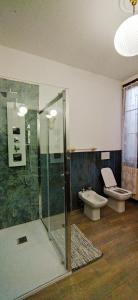 a bathroom with a shower and a toilet and a sink at Villa Mazzini in Molinella