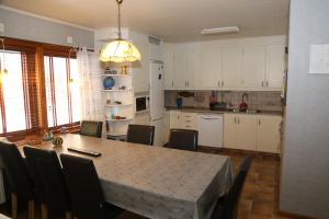 a kitchen with a table and chairs in a room at Nordic character in Vidsel