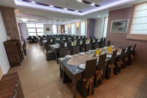 a banquet hall with tables and chairs in a room at Hotel Ivanković in Međugorje +21 photos