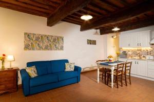 a living room with a blue couch and a table at Azienda Agricola I Colli di Marliano in Lastra a Signa +15 photos