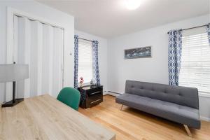 a living room with a couch and a table at Convenient Braintree Home - 3 Bedroom Sleeps 8 in Braintree