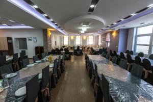 a conference room with long tables and chairs at Hotel Ivanković in Međugorje