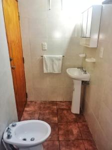 a small bathroom with a sink and a toilet at Complejo Hatun Yaya in Mendoza