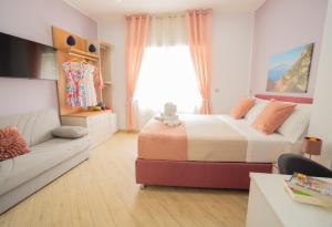 a bedroom with a bed and a couch at SYMPHONY HOUSE in Sorrento