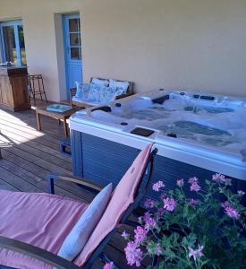 a bedroom with a bed and two chairs and flowers at Domaine du Boscq in Parleboscq