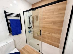 a shower with a glass door in a bathroom at Vincent's House in Barcelona