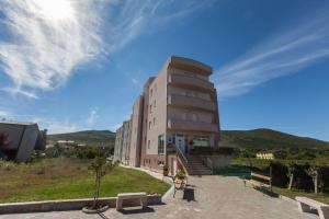 a tall building with stairs and benches in front of it at Hotel Ivanković in Međugorje