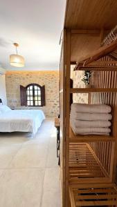 a bedroom with a bed and some towels at Papanestoras Apartments in Kardamili