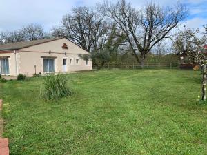 a yard with a house and a fence at Gite au calme à 15 min d'Albi, 7 personnes in Taïx