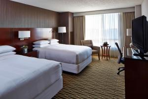 a hotel room with two beds and a flat screen tv at Minneapolis Marriott Southwest in Minnetonka