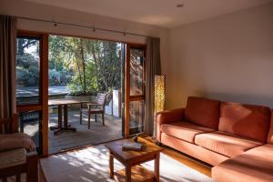 a living room with a couch and a table at Bow Street Studios - The Apartments in Raglan