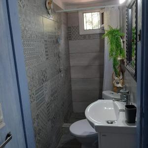 a small bathroom with a sink and a toilet at Boho beach house in Nea Potidaea +55 photos