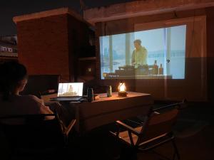 a person sitting at a table with a laptop at Stay Midcentury in Seoul